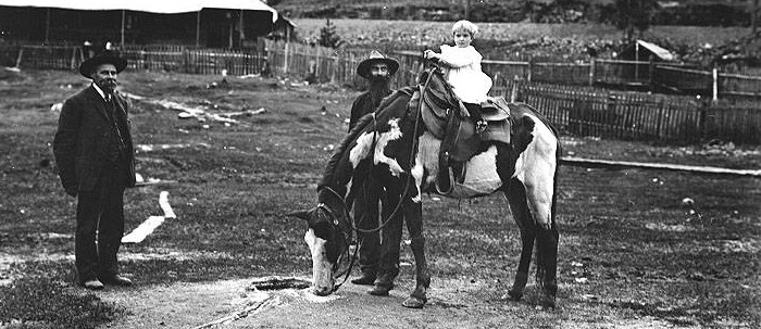 Elcaine Longmire with his brother, grandson, and horse, Old Spot