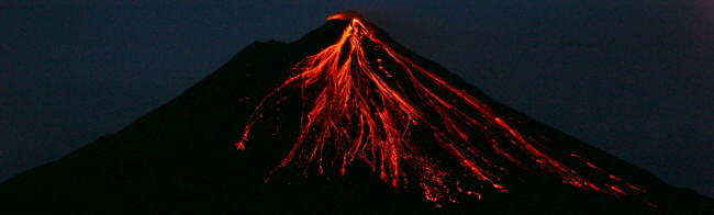 Lava flowing down the slope of Arenal Volcano on a clear night