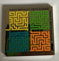 A Day Without Geocaching... Geocoin front
