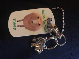 Sheep tag with tiny metal sheep attached