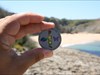 The coin and the Coxos Beach