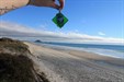 Bounty Mutineer on the coast of New Zealand. Bounty Mutineer visited a spot along Papamoa Beach, New Zealand. &#13;&#10;Here is Bounty hovering over Mt. Maunganui in the distance. North-east coast of the North Island of New Zealand.