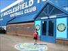 In front of Macclesfield Town FC, held by Jake