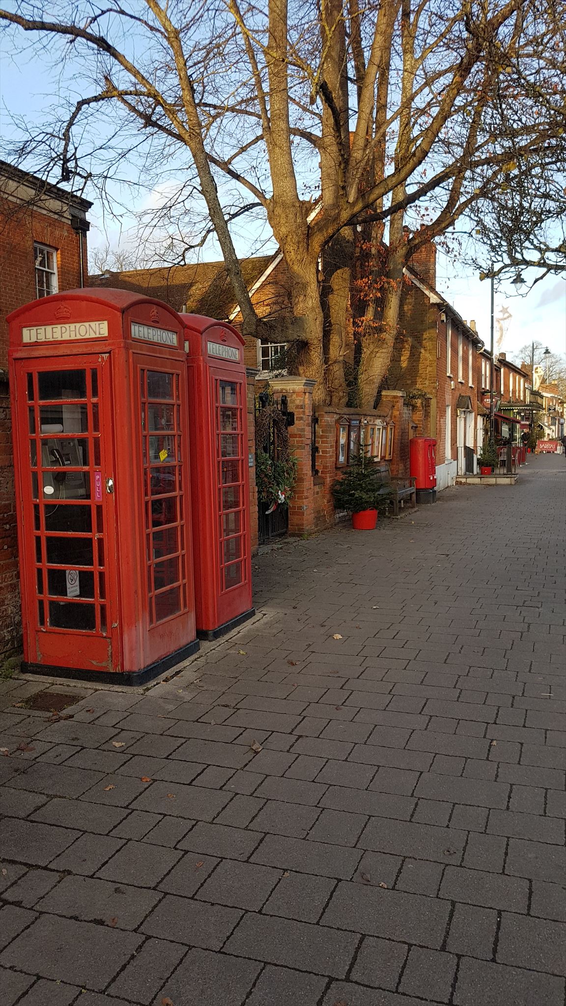 A pair of pairs. Two telephone boxes and two post boxes.